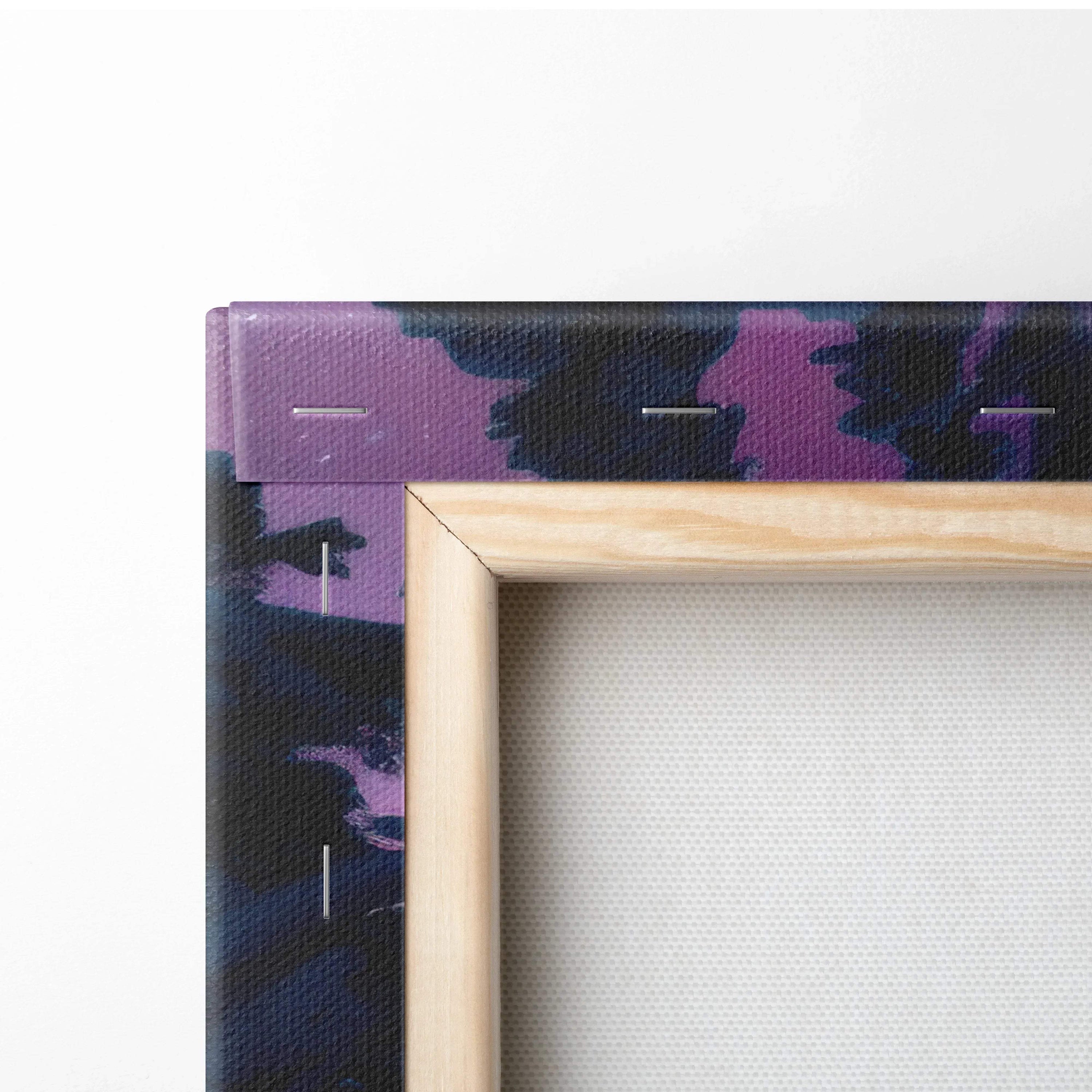 Close-up of natural wood frame corner on thick canvas wall art with dark purple and black snowy forest design.