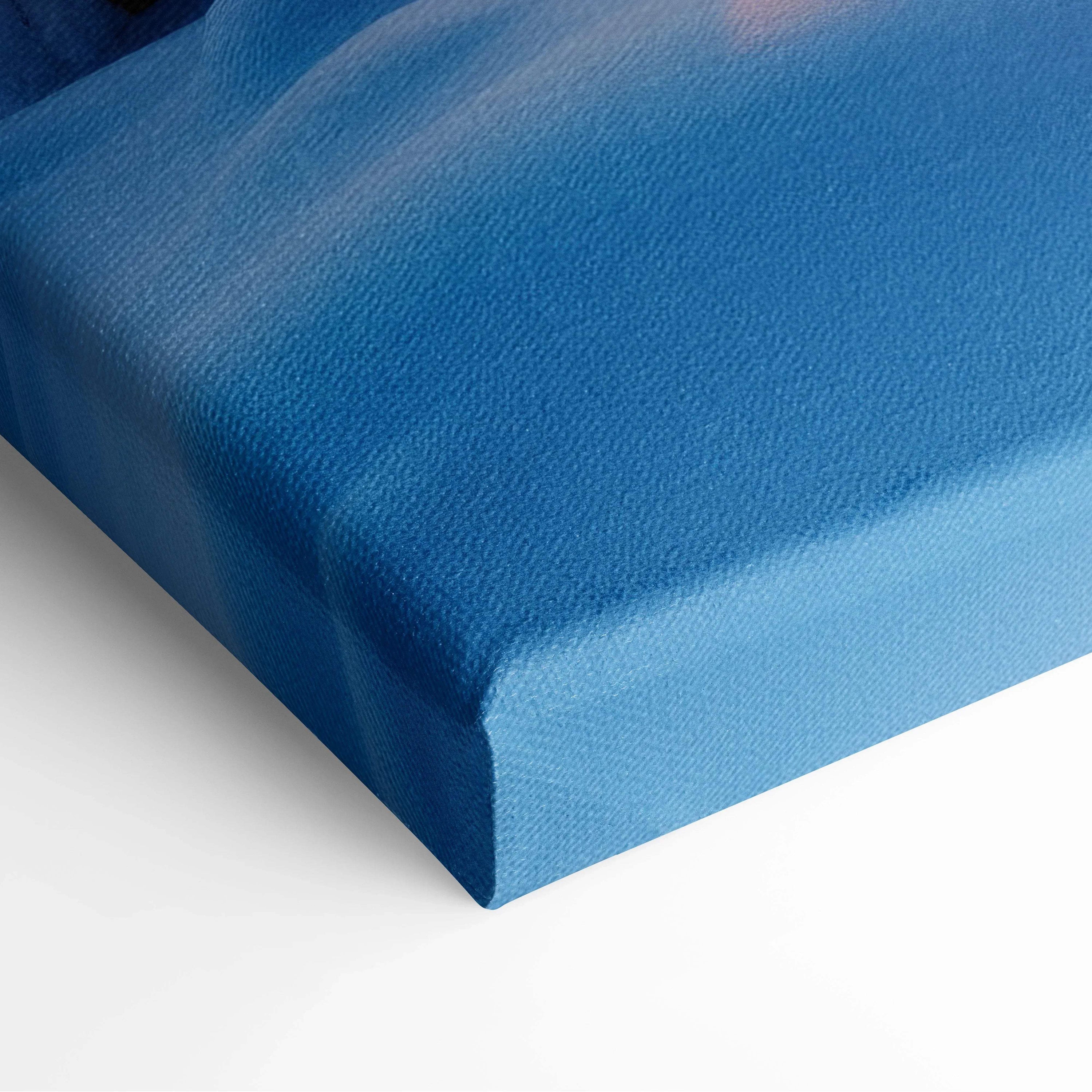 Close-up of blue canvas texture stretched over a thick wooden frame, showcasing high-resolution print quality for wall art.