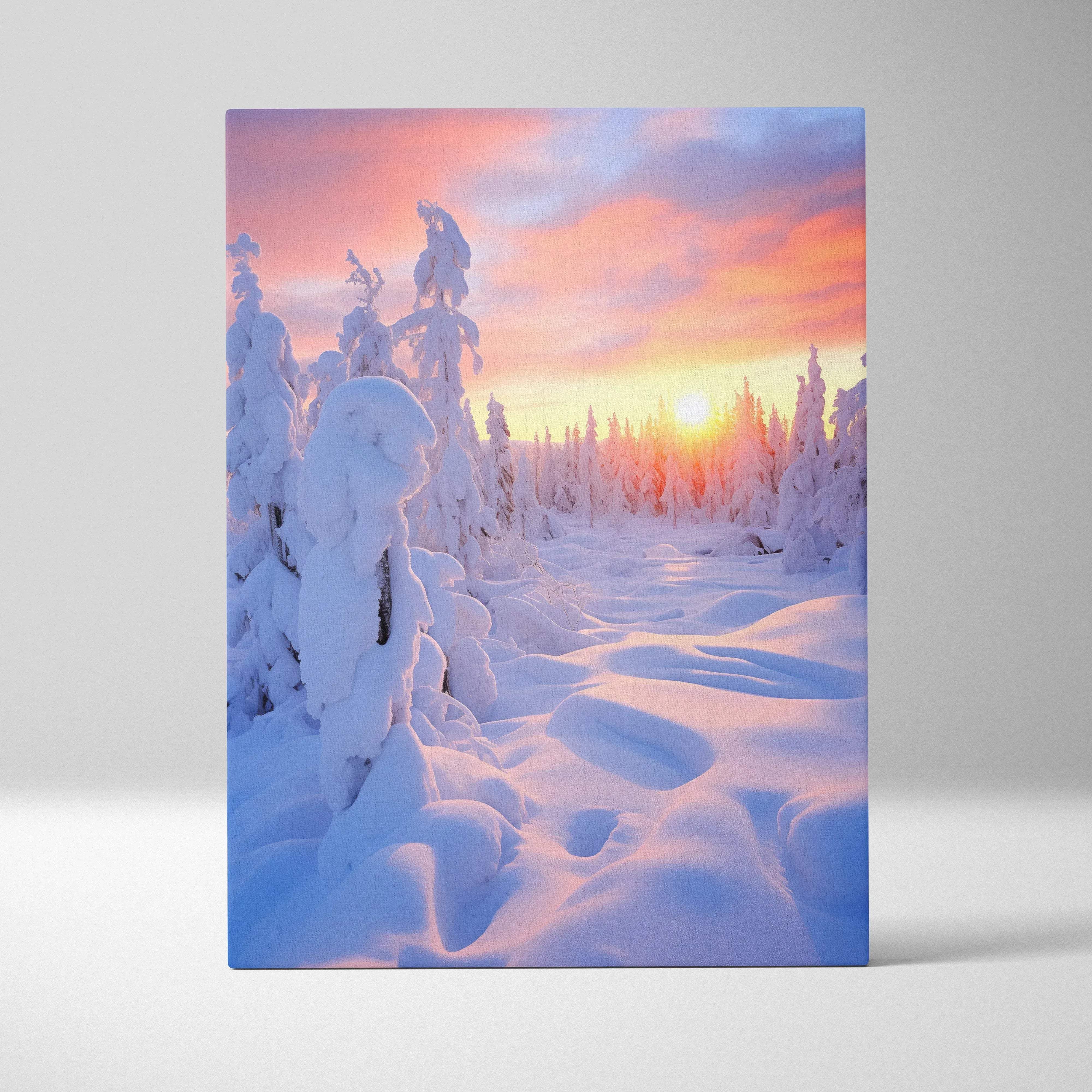 Winter landscape canvas wall art showing snow-covered pines with a vibrant pink orange and purple sunset glow