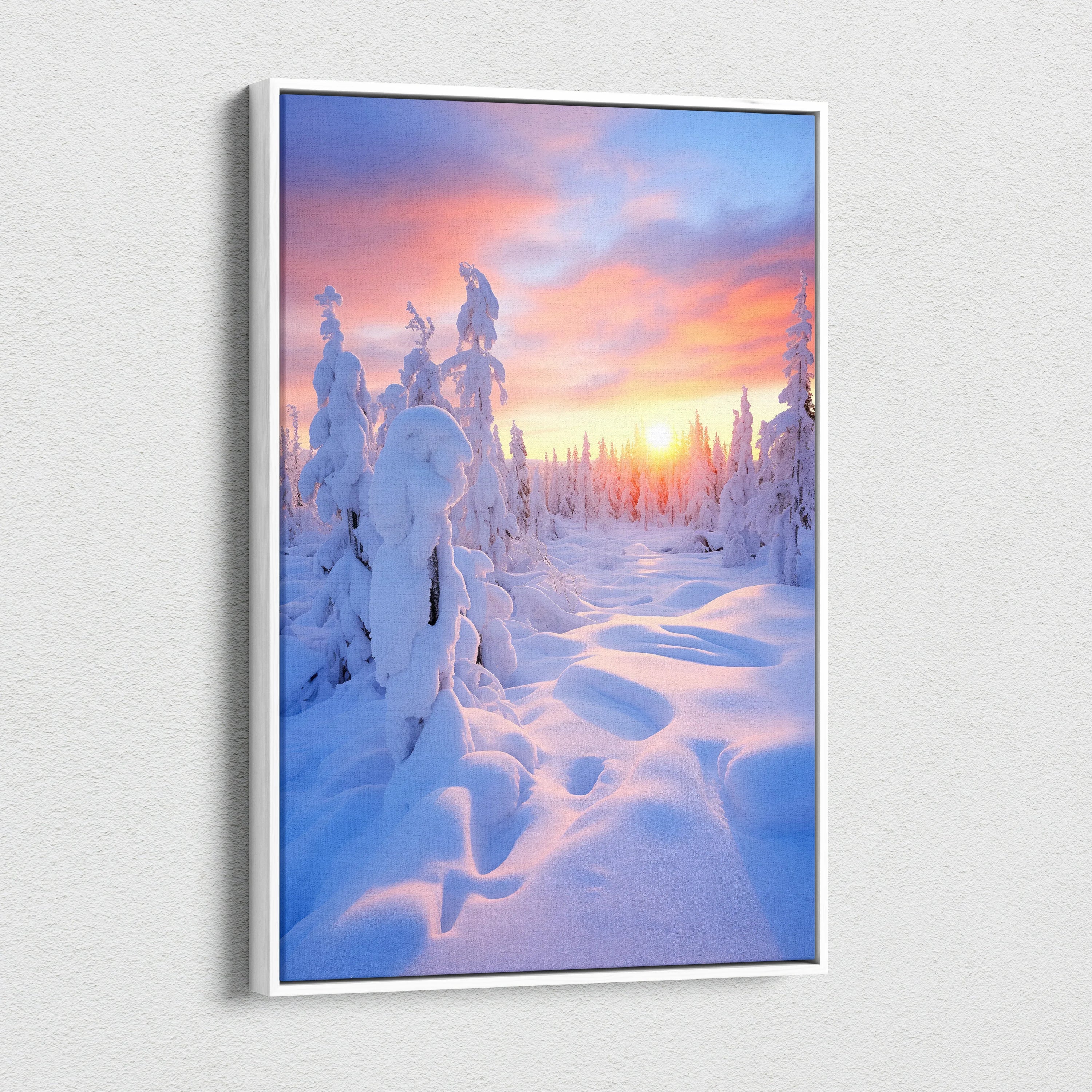 Canvas wall art featuring a snowy forest landscape at sunset with vibrant pink, orange, and purple sky colors.