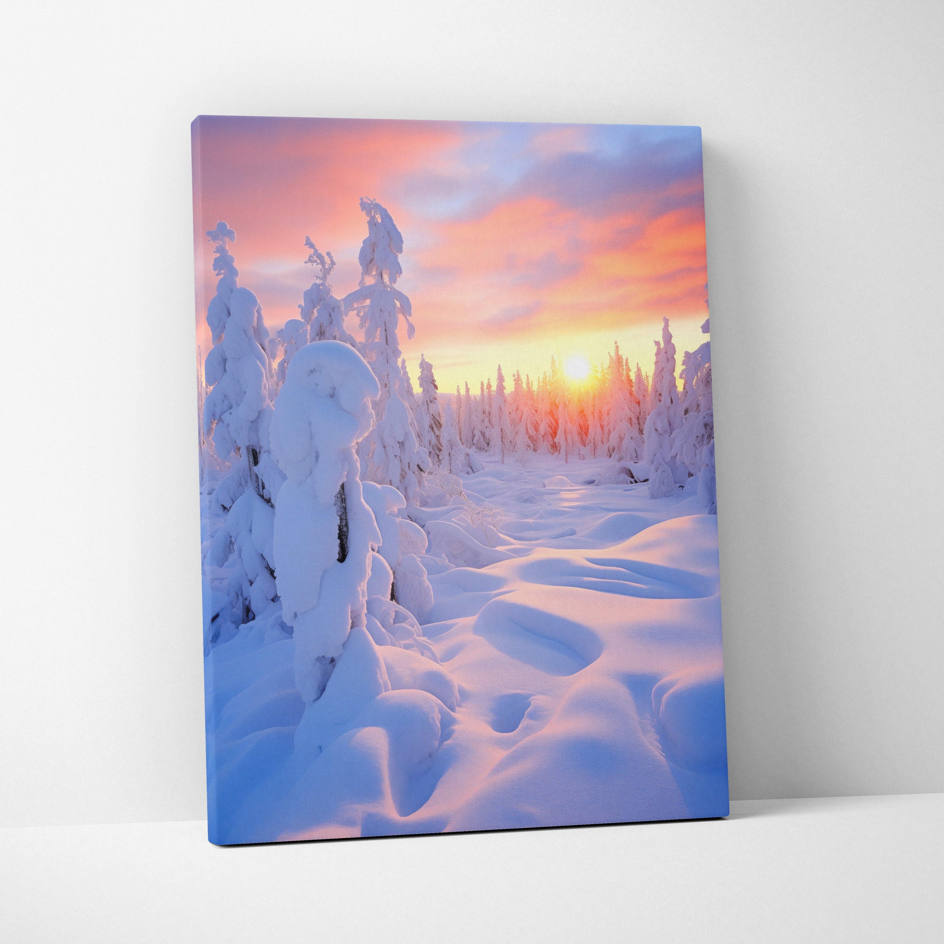 Canvas wall art featuring a snowy forest landscape at sunset with soft pink and orange sky tones.