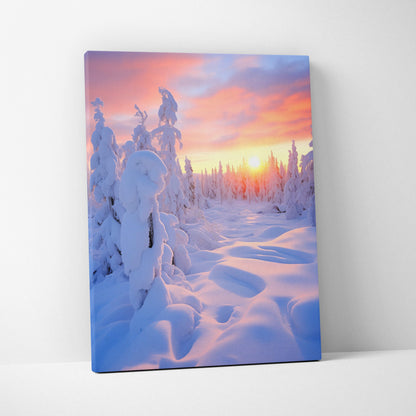 Canvas wall art featuring a snowy forest landscape at sunset with soft pink and orange sky tones.