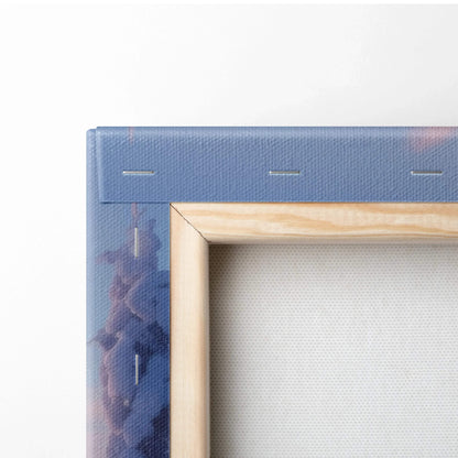 Close-up of wooden frame and blue canvas corner with subtle snowy landscape print on textured fabric wall art.
