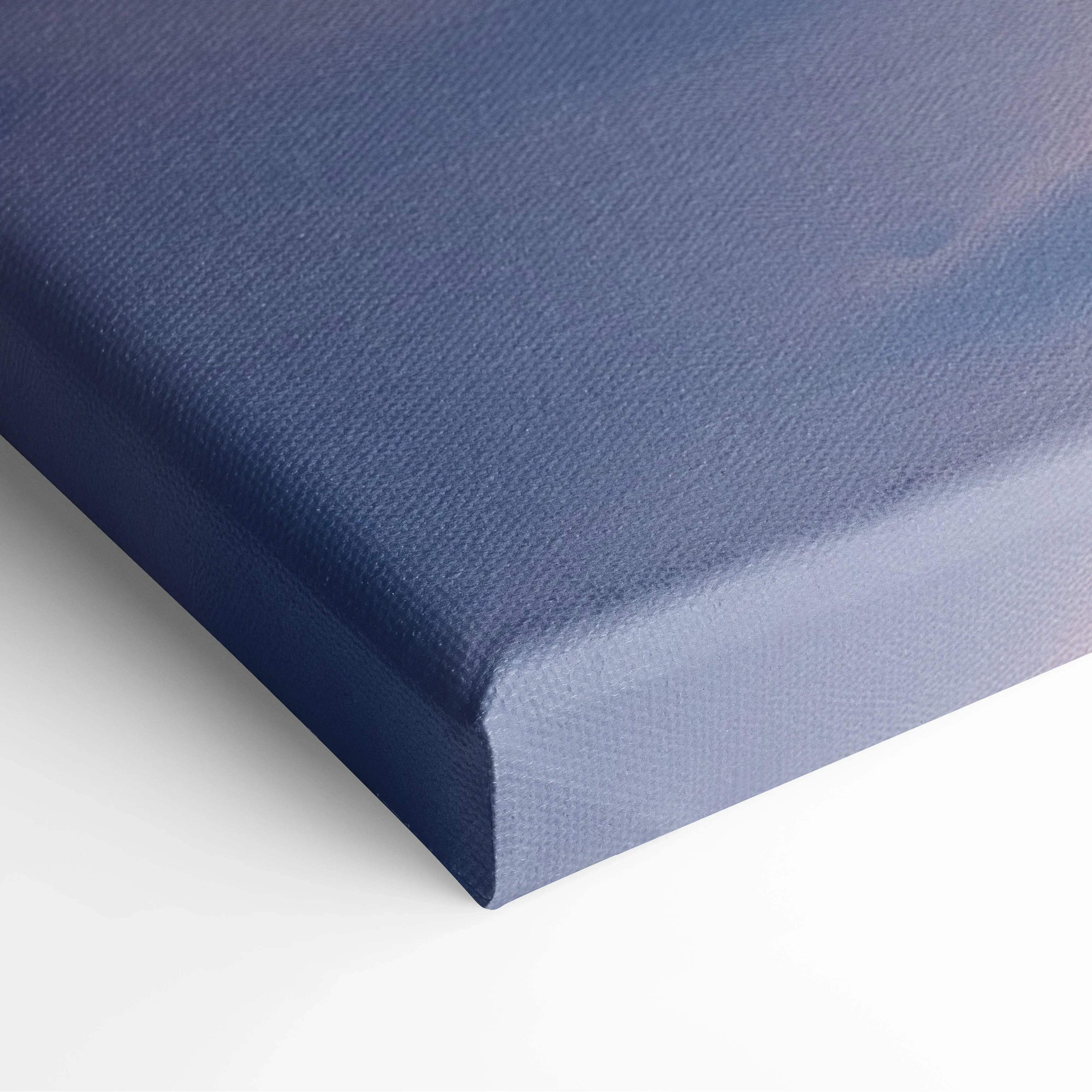 Close-up of wrapped canvas corner showing blue textured fabric for wall art decor.
