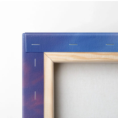 Close-up of wooden stretcher frame and blue canvas edge with subtle pink and orange hues for wall art decor.