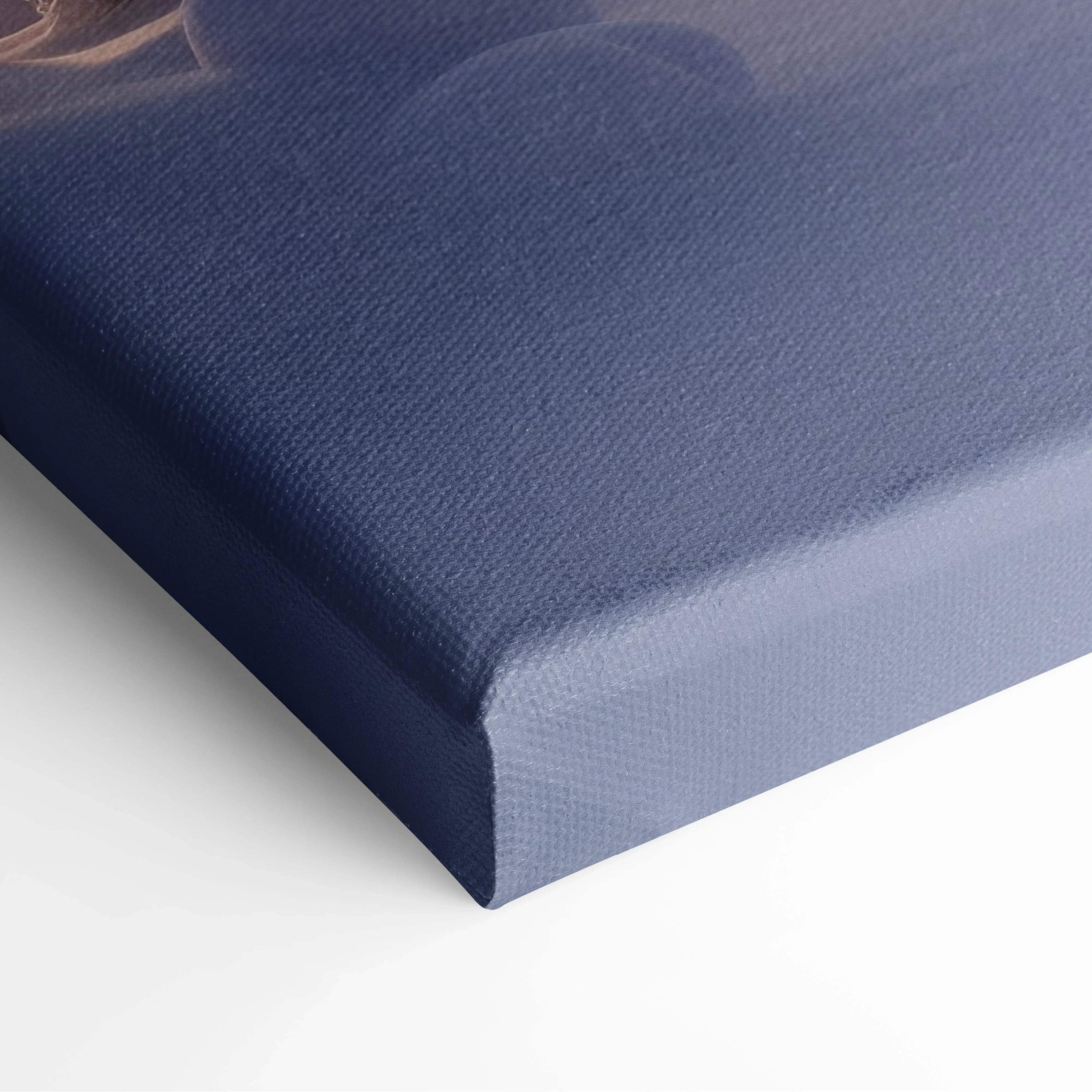 Close-up of canvas wall art showing a textured edge with dark blue and purple hues in a winter scene print.