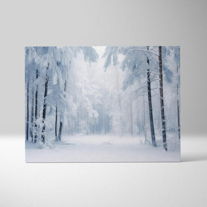 Canvas wall art featuring a serene snowy forest with tall trees covered in frost against a pale blue winter sky.