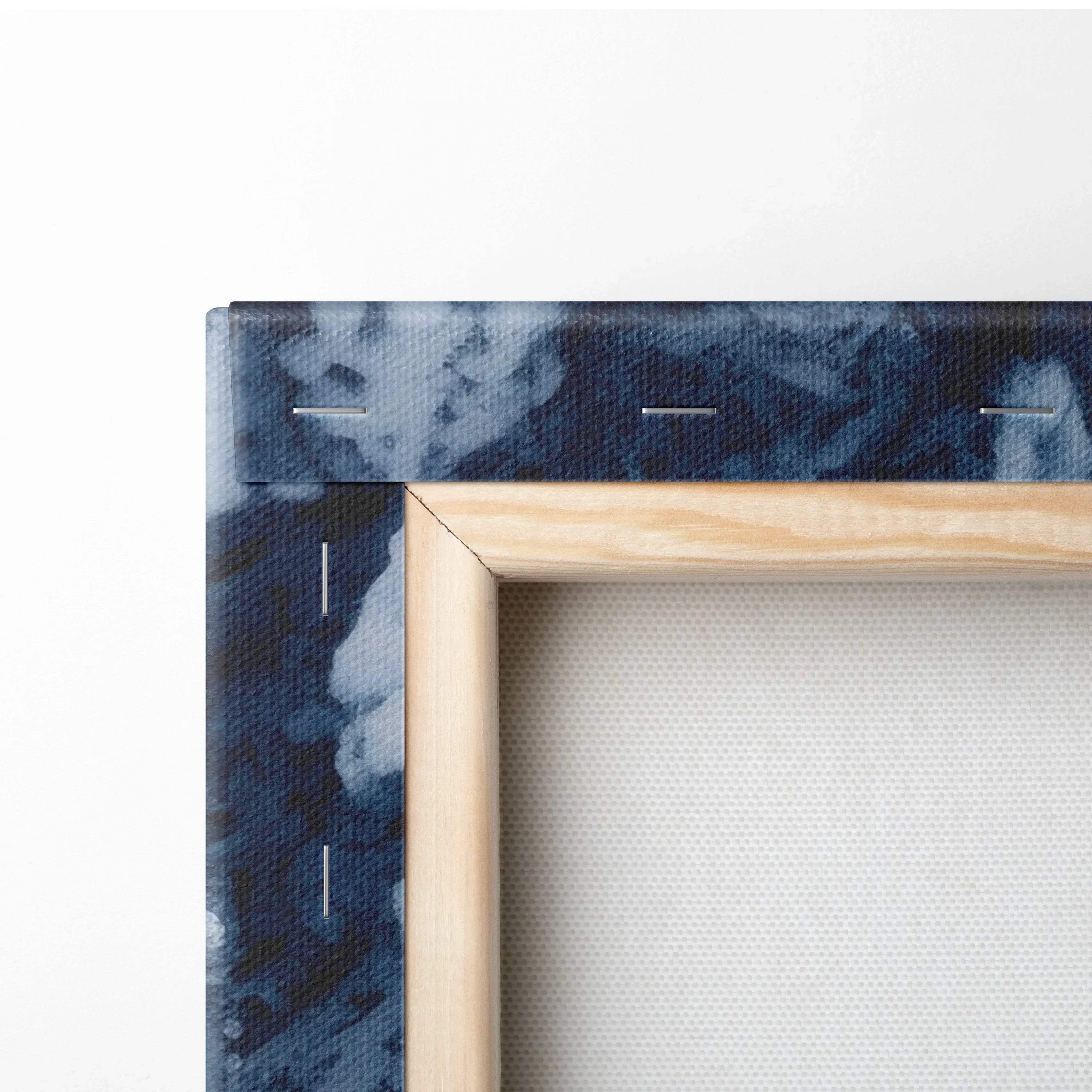 Close-up of canvas wall art corner showing textured deep blue forest pattern with wooden frame edges and white canvas.