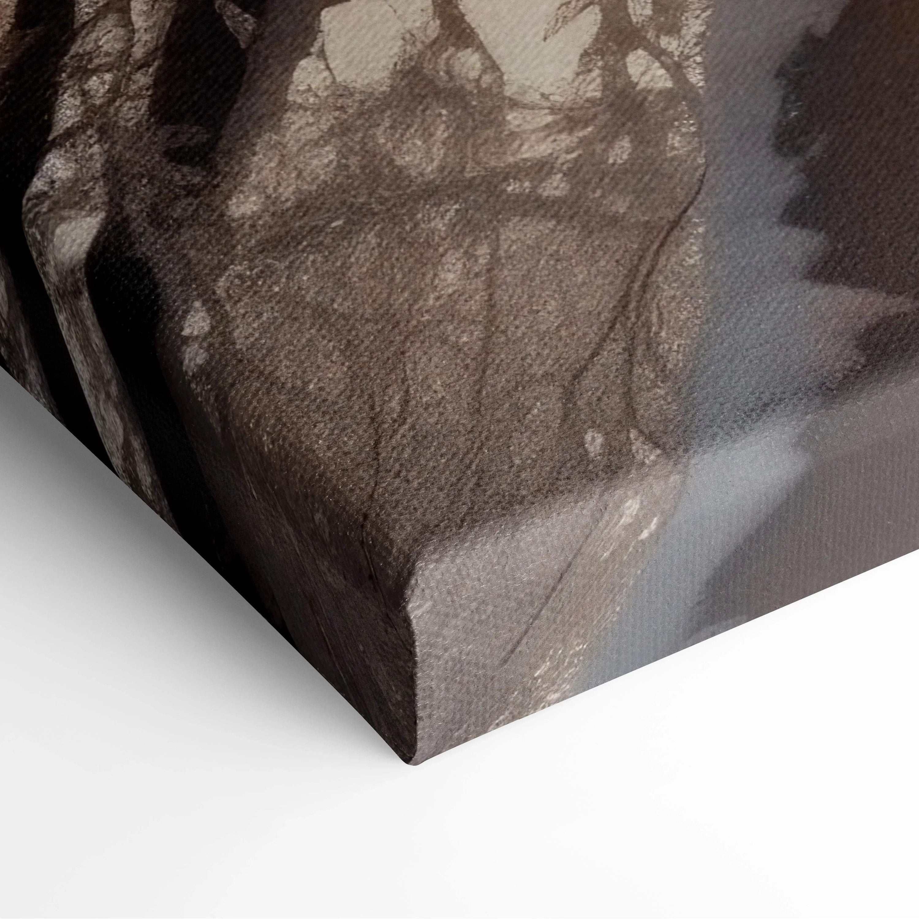 Close-up of textured canvas wall art corner featuring dark, muted tones and subtle forest shadow details.