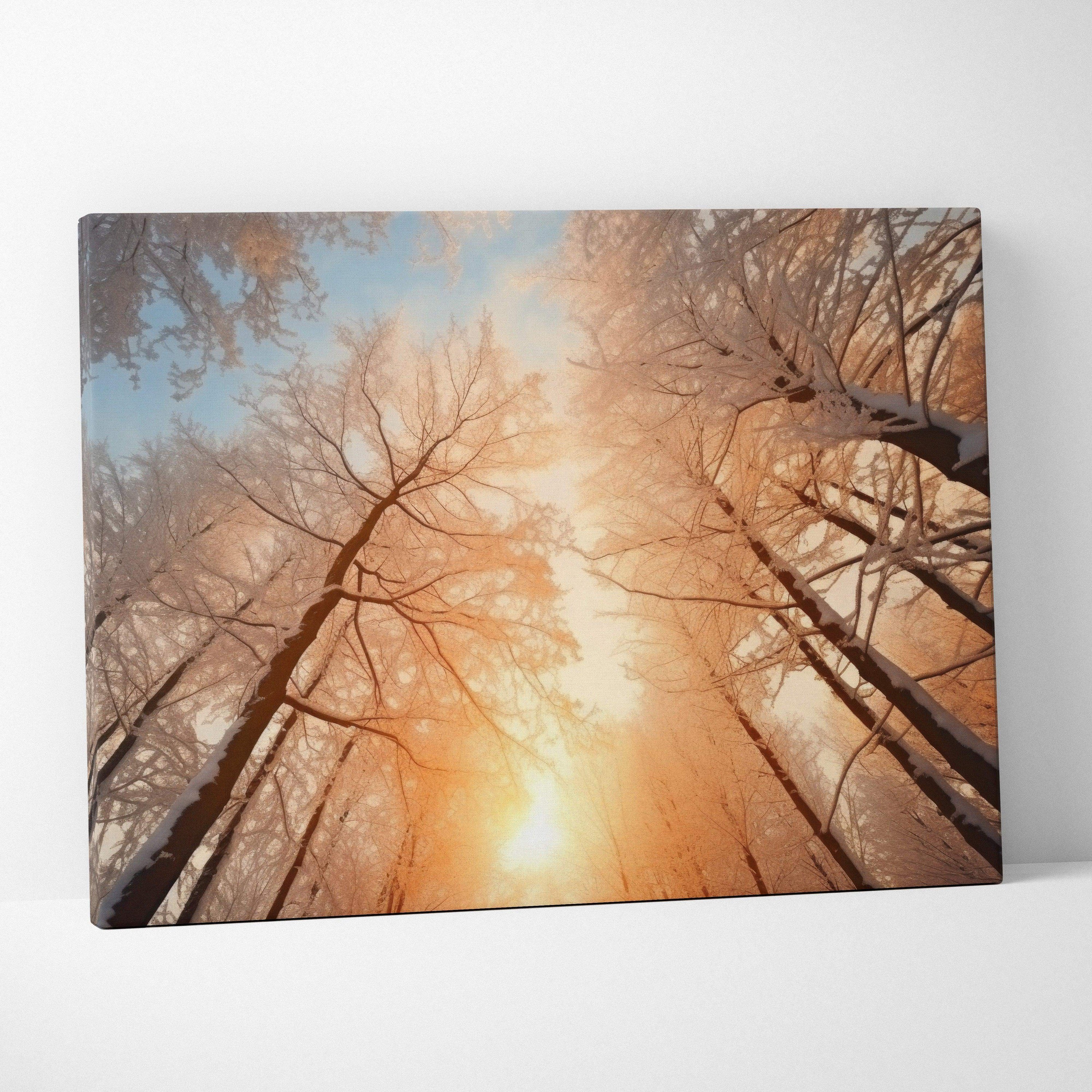 Canvas wall art featuring a snowy forest with tall trees and a warm orange sunset sky.