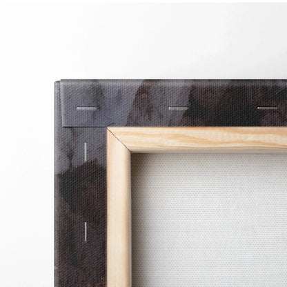 Close-up of a wooden stretcher frame with folded black canvas edge, showing textured fabric and stapled corners.
