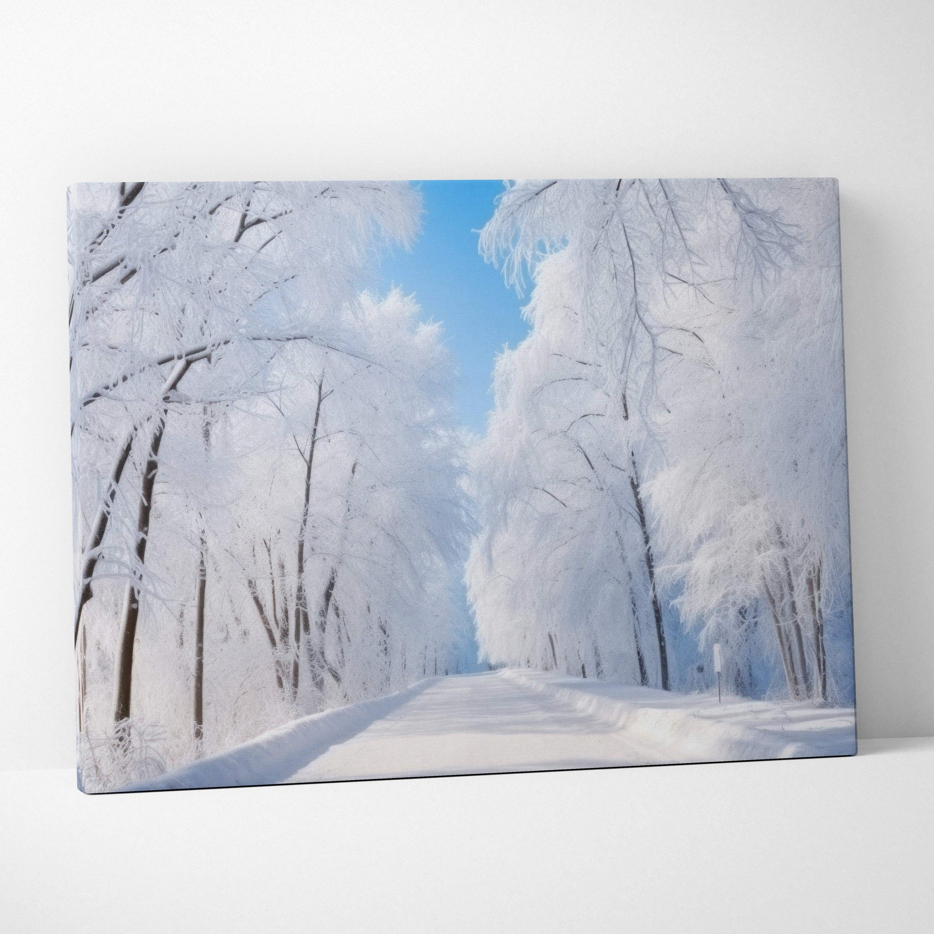 Canvas wall art featuring a dreamy winter landscape with snow-covered trees and a clear blue sky.