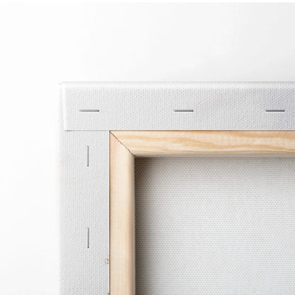 Close-up of stretched white canvas on wooden frame for wall art display.