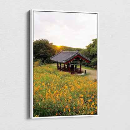 Canvas wall art featuring vibrant yellow flowers with a traditional Asian pavilion at sunset.