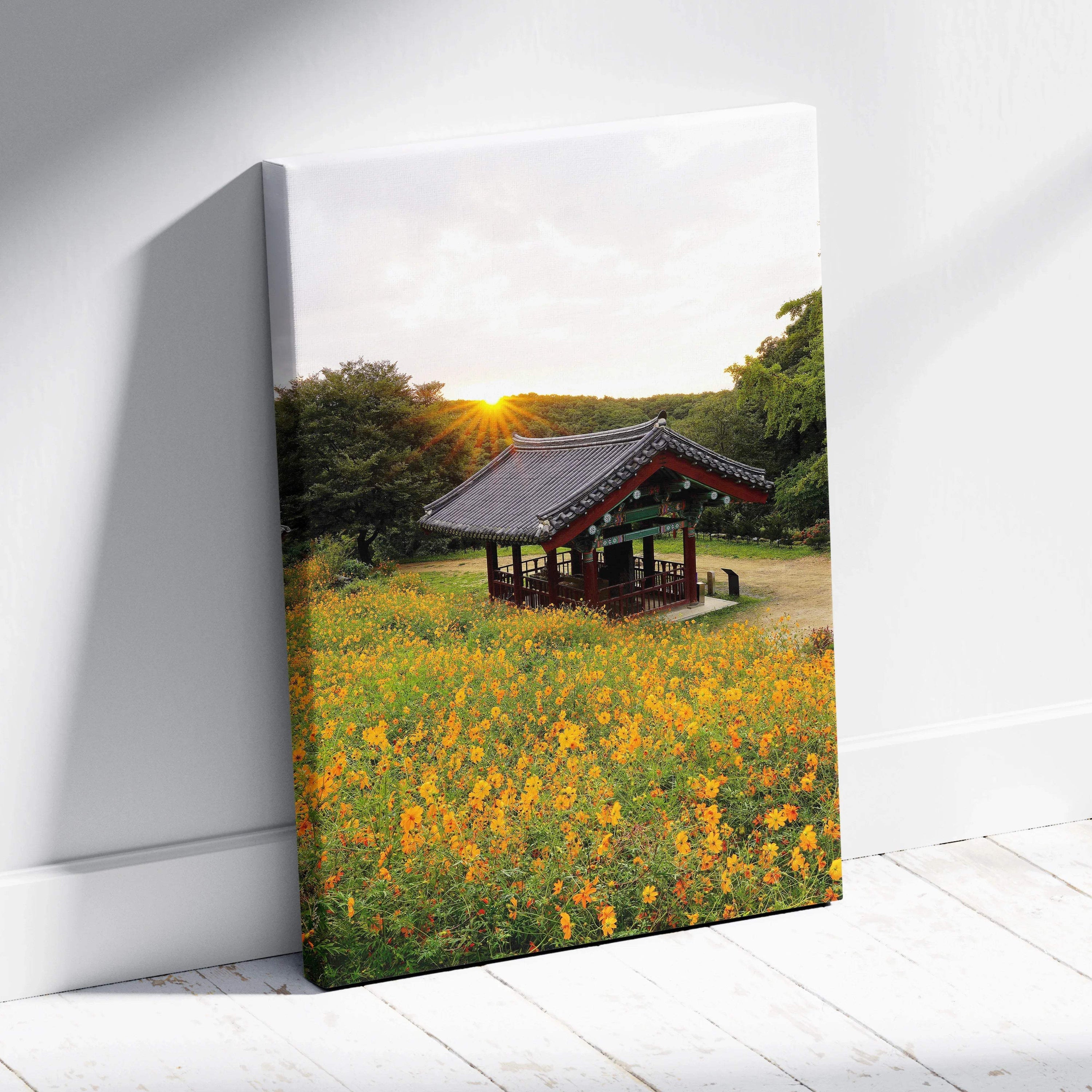 Canvas wall art featuring vibrant yellow flowers in front of a traditional Asian architectural pavilion at sunset.