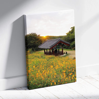Canvas wall art featuring vibrant yellow flowers in front of a traditional Asian architectural pavilion at sunset.