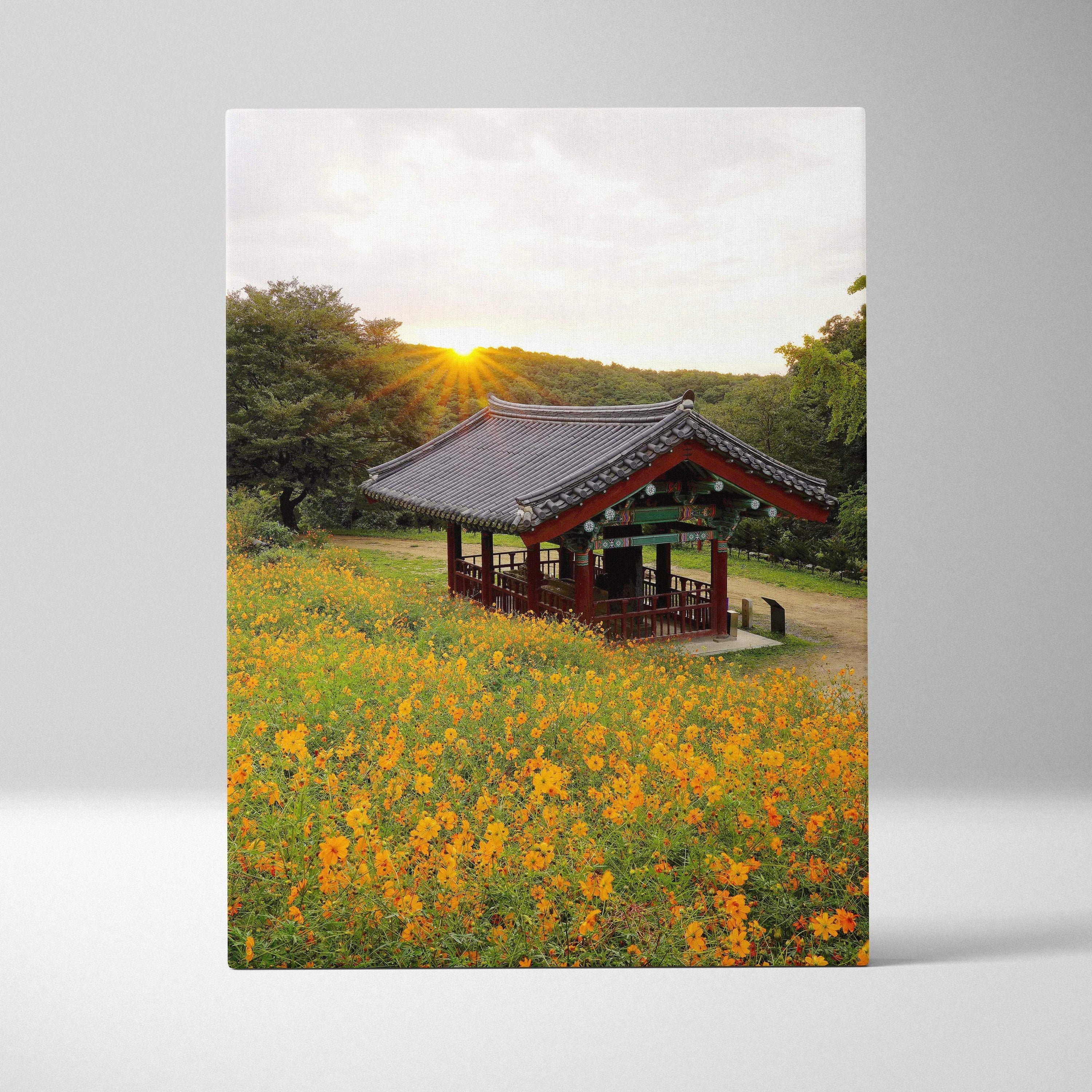 Canvas wall art of a sunlit traditional pavilion surrounded by vibrant yellow flowers and lush greenery.